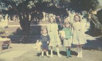 The Easter picture shows the four of us on Easter '62, standing in the middle of the court. The front houses behind us are on Hudson. Both photos are taken from the same viewpoint. Where we're standing is where Gracia used to sit with little Jack.